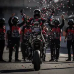 An Aprilia rider and his team celebrating a victory in parc fermé after a MotoGP race.
