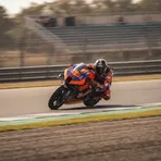 South African rider Brad Binder walking away from his Red Bull KTM bike in the pit lane, symbolising his departure from the team.